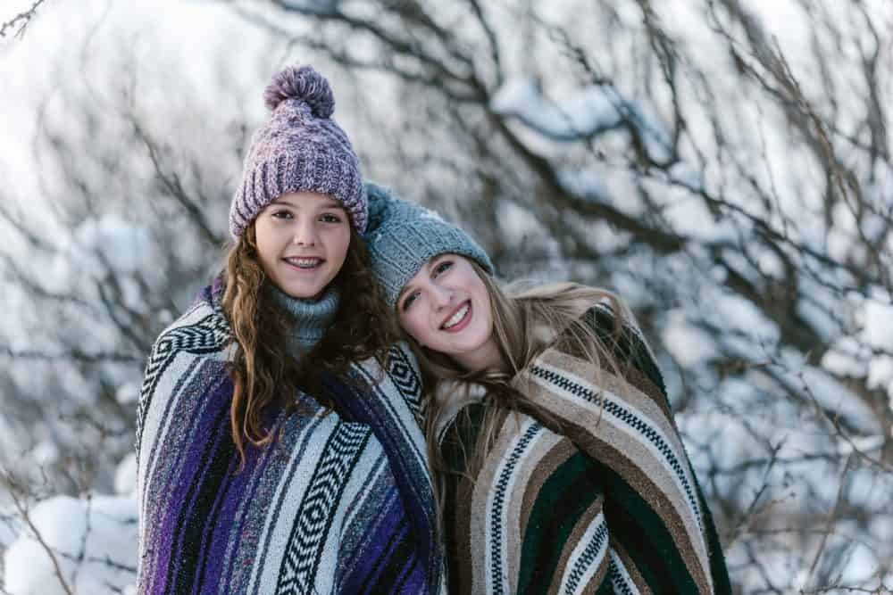 two girls smiling in winter